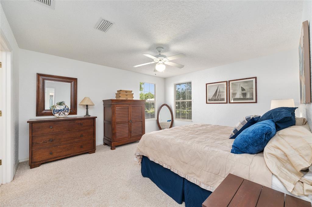 8038 Southwest 108th Loop Ocala, FL 34481 - Photo 18 of 48 a bedroom with a bed and a dresser