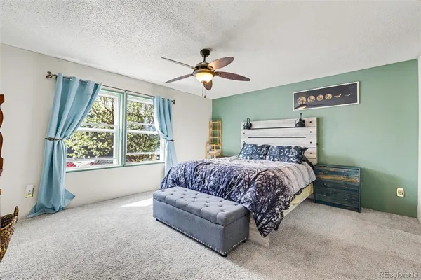 a spacious bedroom with a bed and a chandelier