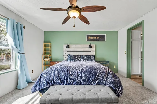 a bedroom with a large bed and a chandelier