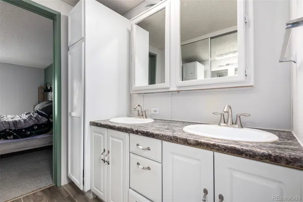 a bathroom with a granite countertop sink and a mirror