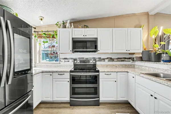 a kitchen with a stove oven and a refrigerator