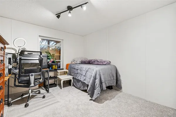 a bedroom with a bed and a desk
