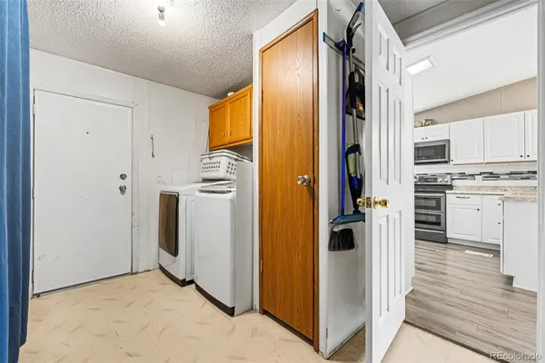 a kitchen with stainless steel appliances granite countertop a refrigerator and a stove