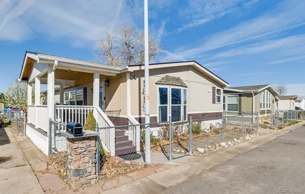 a front view of a house with wooden fence
