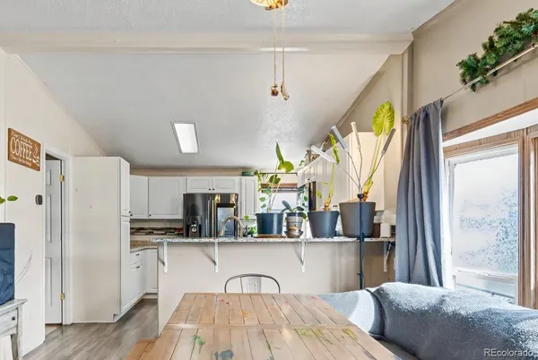 a kitchen with stainless steel appliances a refrigerator sink and cabinets