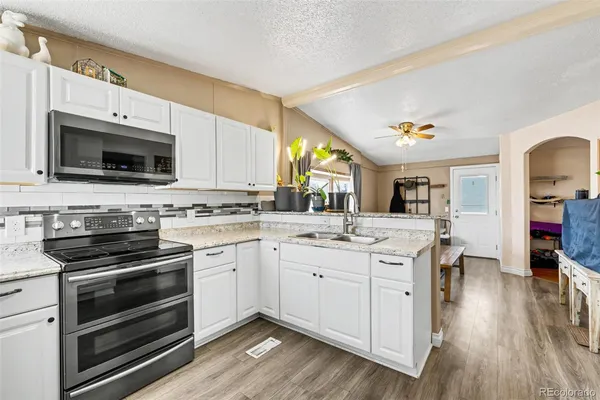 a kitchen with a sink stove and cabinets