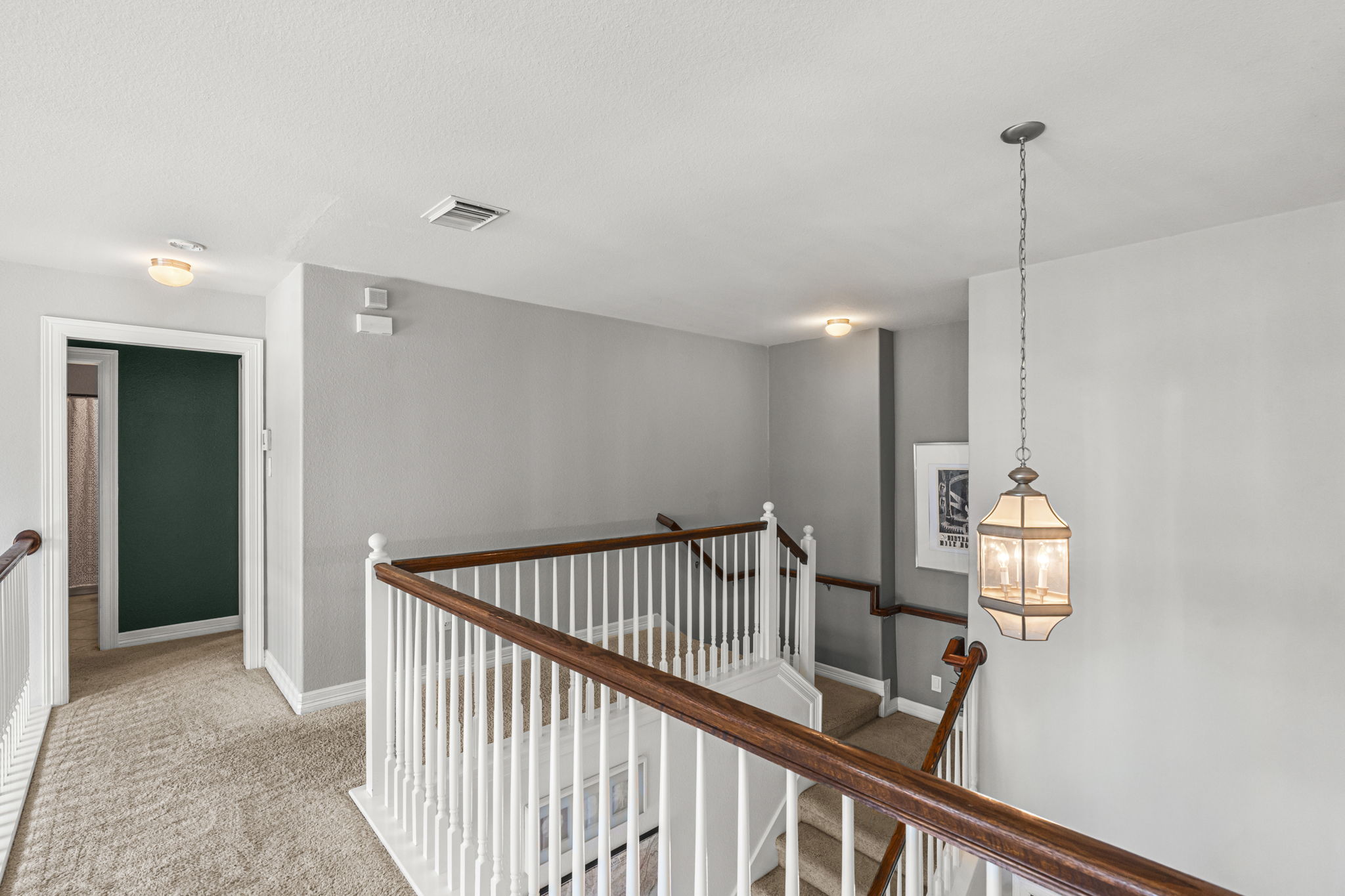 454 Fall Circle Kyle, TX 78640 - Photo 30 of 39 A well-lit second-story landing offers a bright and inviting space with warm carpeting and elegant railing details.