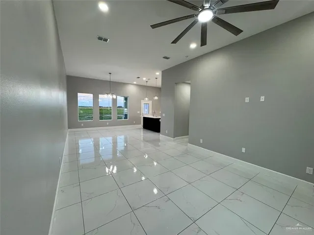 a view of a kitchen with kitchen island granite countertop a large window