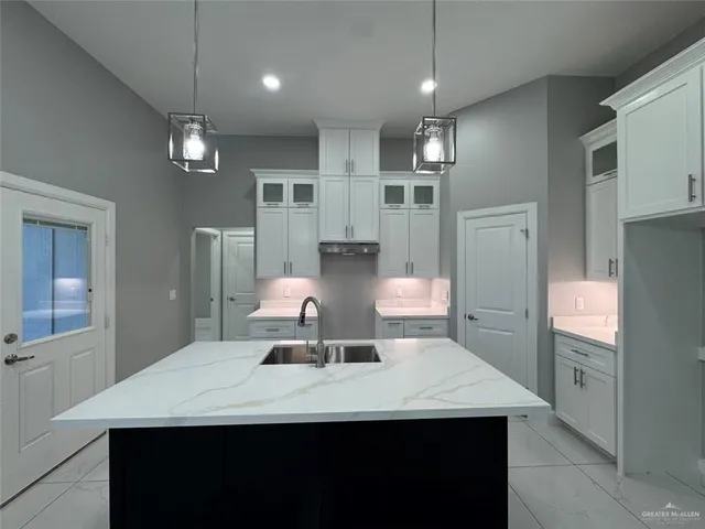 a kitchen with a sink a counter space and stainless steel appliances