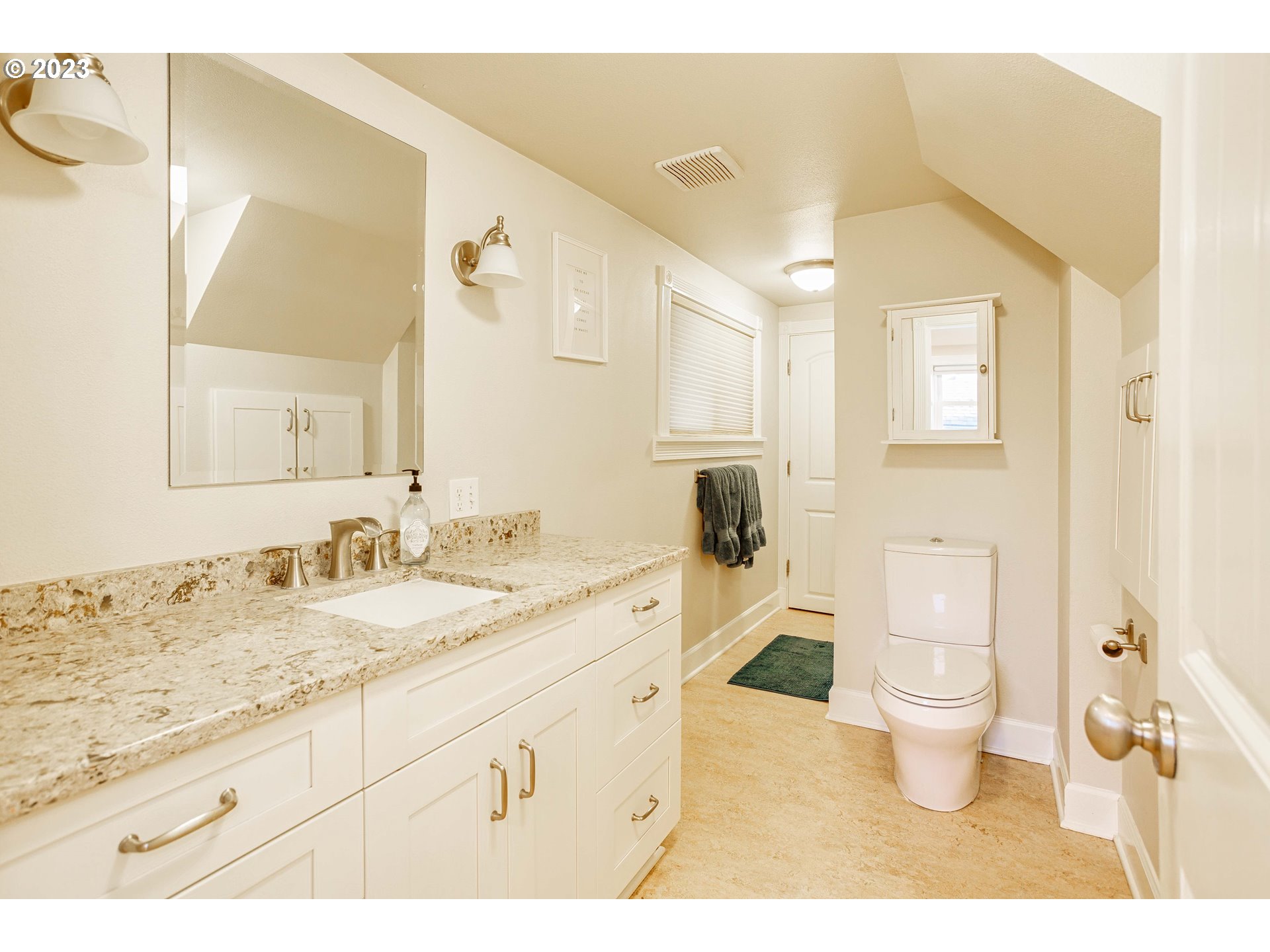210 South 4th Avenue Ridgefield, WA 98642 - Photo 16 of 31 a bathroom with a granite countertop sink a toilet and a mirror
