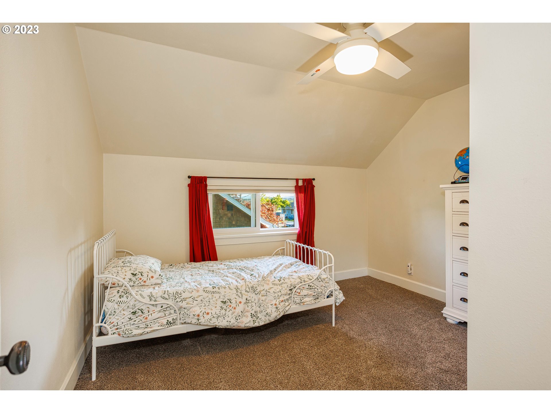 210 South 4th Avenue Ridgefield, WA 98642 - Photo 21 of 31 a bedroom with a bed and a chandelier