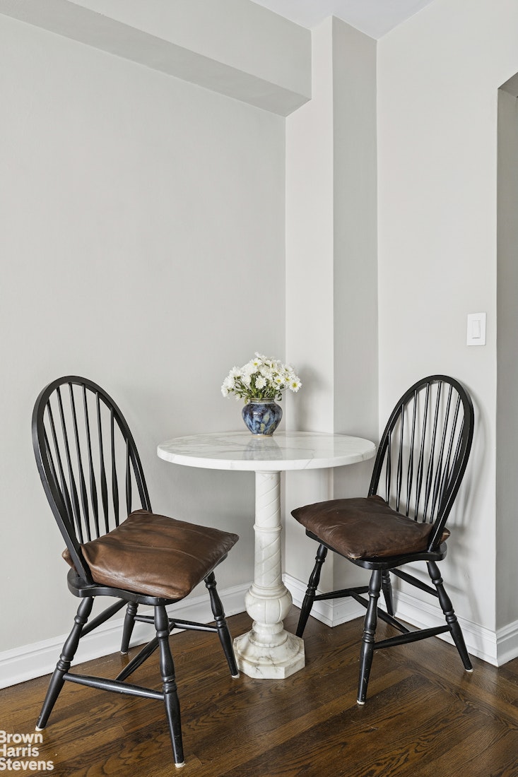 210 East 73rd Street, Unit 7F Manhattan, NY 10021 - Photo 11 of 13 a view of a room that has a table and chairs