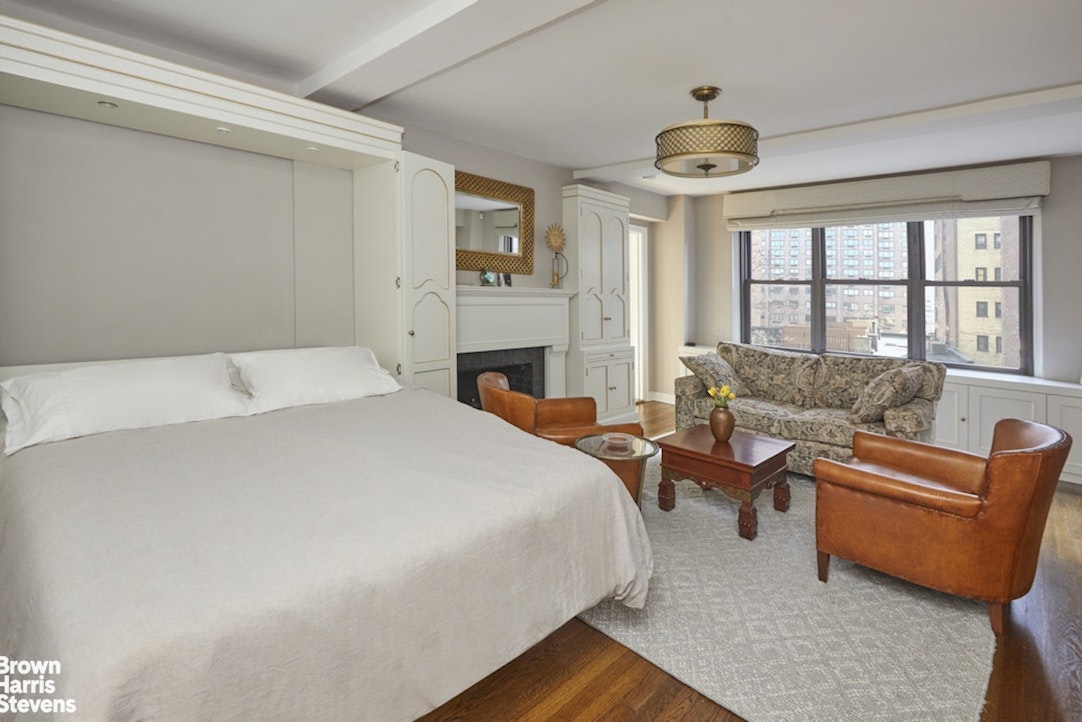 210 East 73rd Street, Unit 7F Manhattan, NY 10021 - Photo 3 of 13 a spacious bedroom with a bed and a couch next to a window