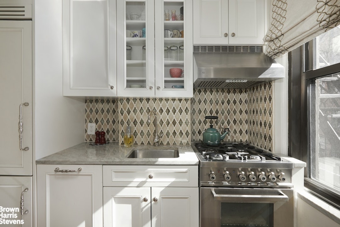 210 East 73rd Street, Unit 7F Manhattan, NY 10021 - Photo 4 of 13 a kitchen with a stove and cabinets