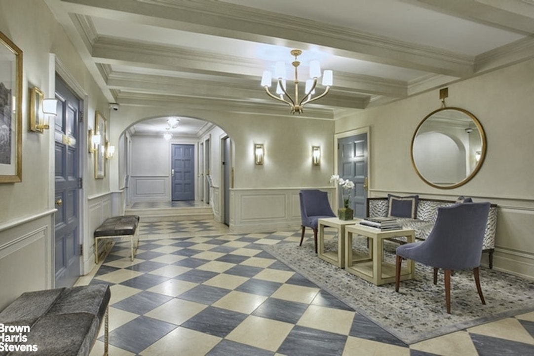 210 East 73rd Street, Unit 7F Manhattan, NY 10021 - Photo 6 of 13 a view of a livingroom with furniture and a mirror