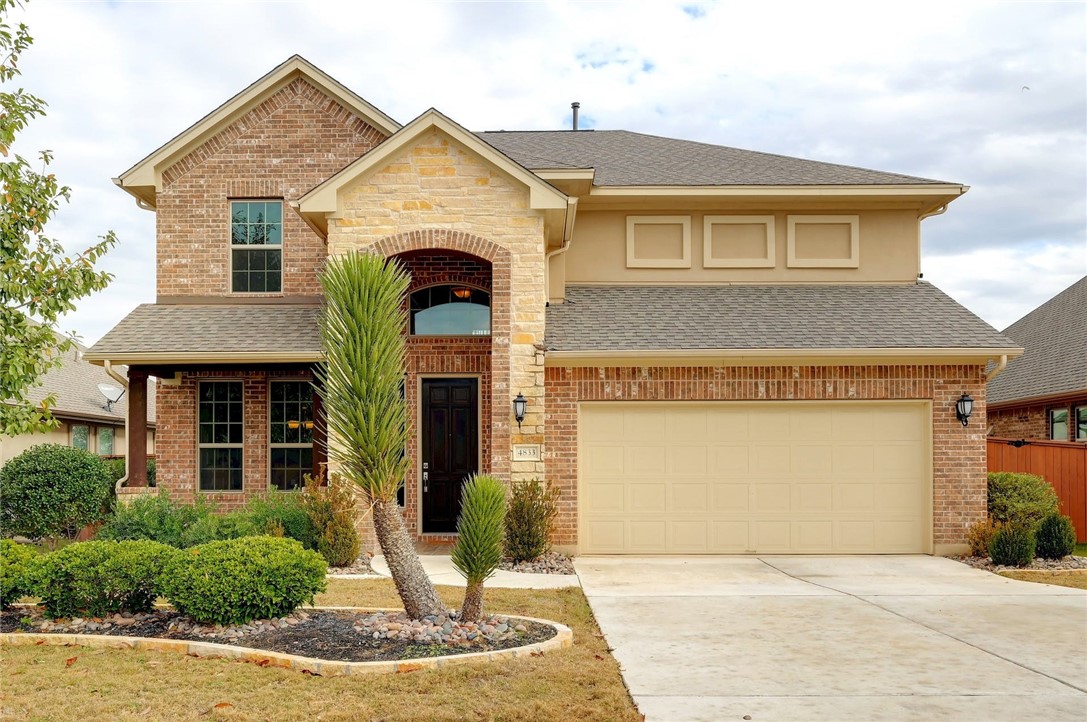 4833 Terraza Trail Round Rock, TX 78665 - Photo 1 of 1 a front view of a house with garden