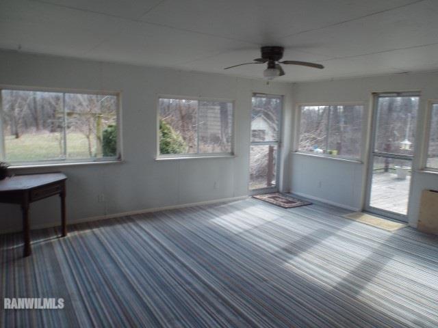 5299 West Nobis Road Hanover, IL 61041 - Photo 18 of 24 a view of empty room with wooden floor and fan