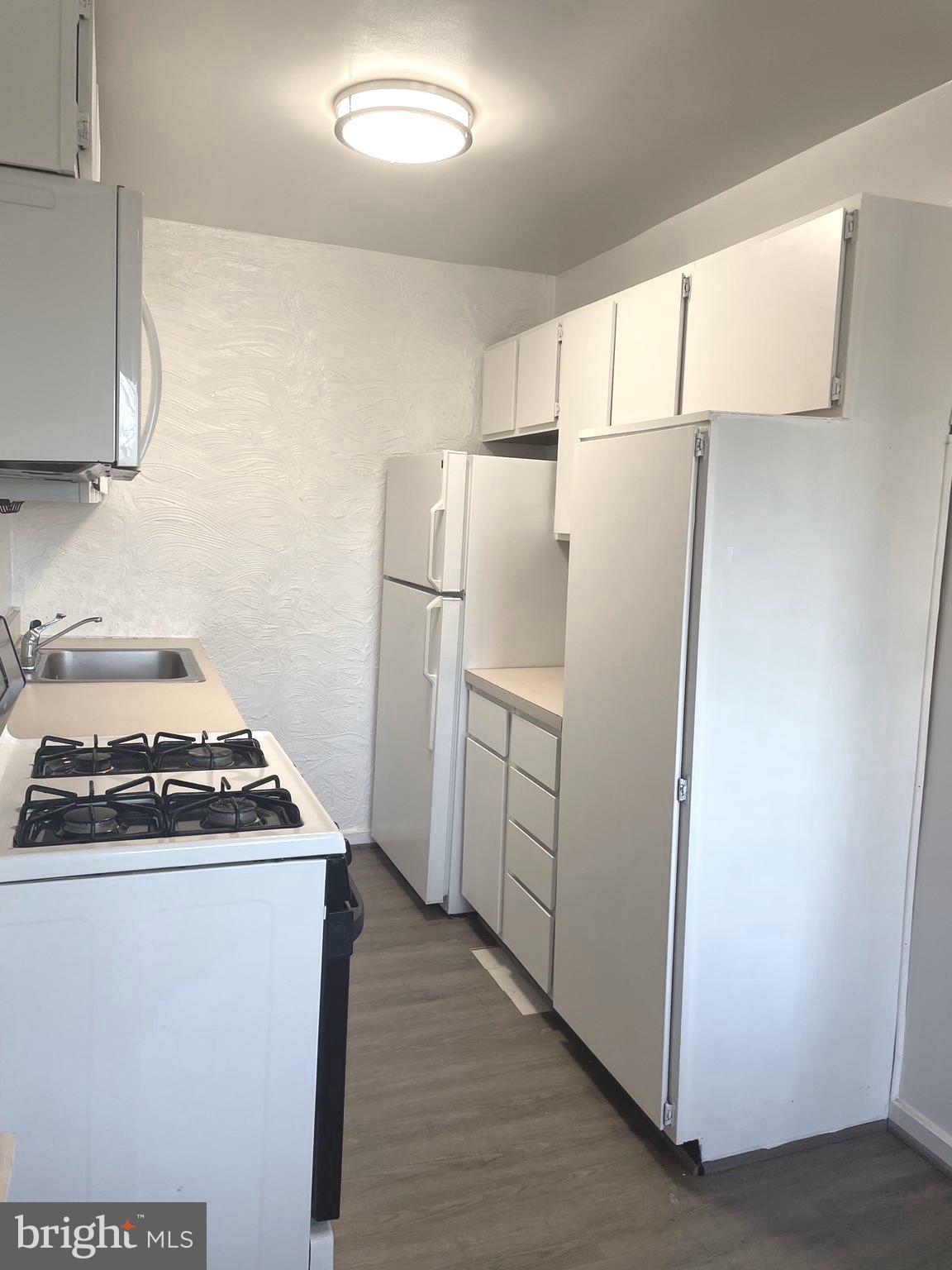 1200 South Arlington Ridge Road, Unit 503 Arlington, VA 22202 - Photo 14 of 17 a kitchen with a white stove top oven and refrigerator