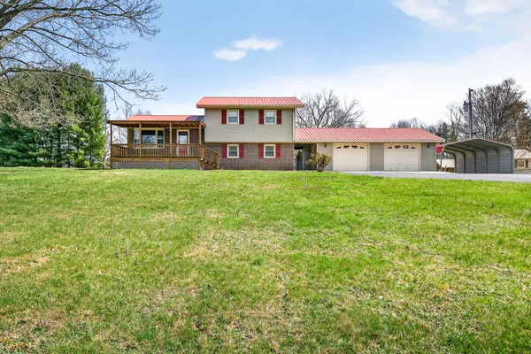 a view of a house with a yard and garage