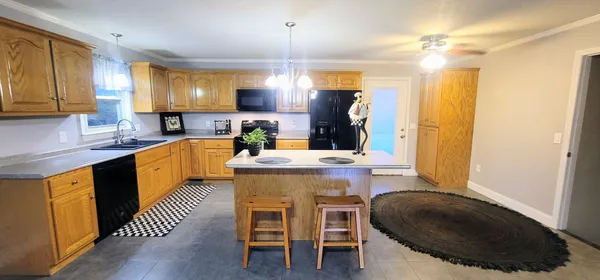 a kitchen with stainless steel appliances granite countertop a sink and a counter space