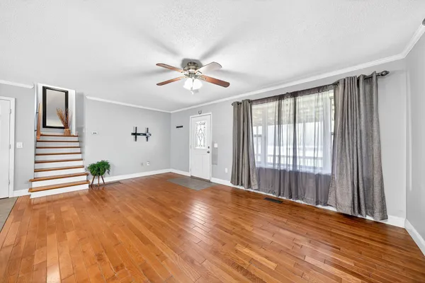 a bedroom with a bed and a large mirror on the dresser