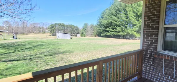a view of a brick house with a porch