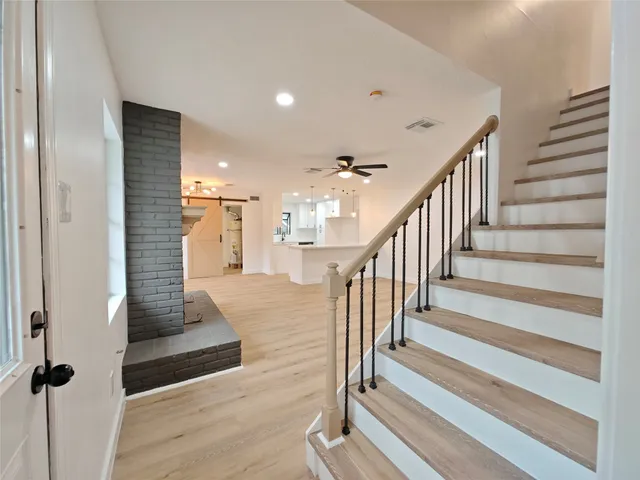 a view of entryway and hall with wooden floor