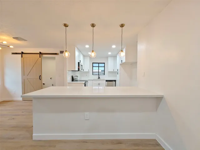 a view of a kitchen with kitchen island