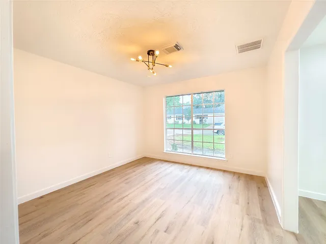 a view of a room with wooden floor and fan