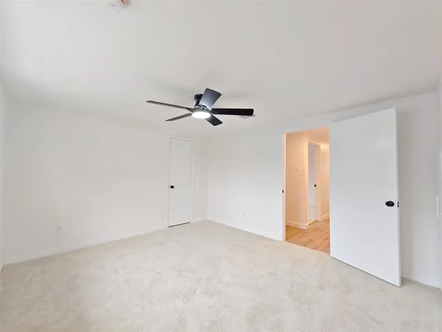 a view of a room with a ceiling fan