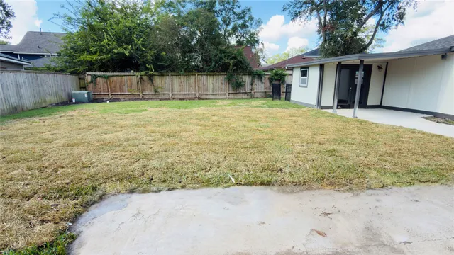 a view of a backyard with a small cabin and a chair