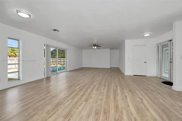 a bed room with a bed a couch and a window