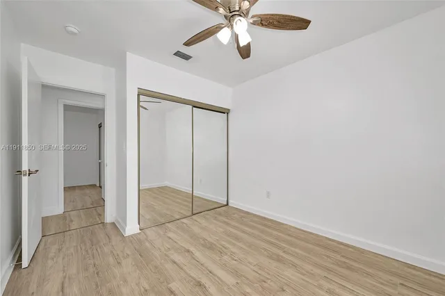 a view of a room with wooden floor
