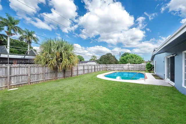 a view of a backyard with swimming pool