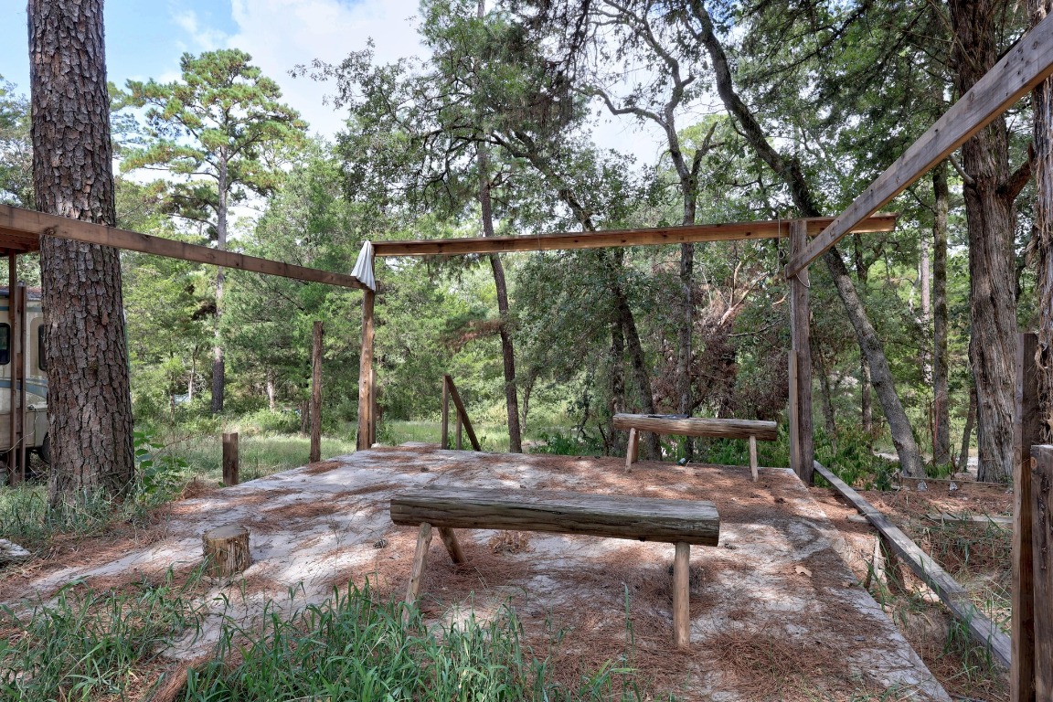 128 Barras Road Paige, TX 78659 - Photo 10 of 12 a backyard of a house with lots of green space and outdoor seating