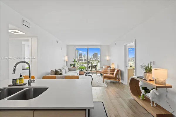 a living room with furniture and a sink