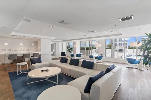 a living room with furniture a wooden floor and chandelier