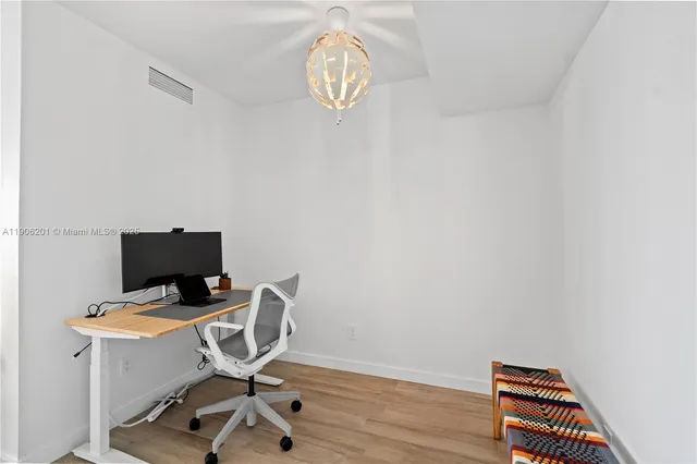 a view of workspace with wooden floor windows