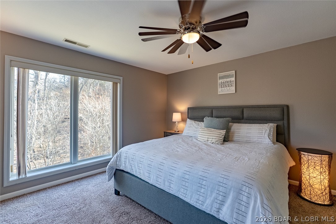 100 Osage Hills Road, Unit 504 Lake Ozark, MO 65049 - Photo 23 of 55 Primary suite facing the woods