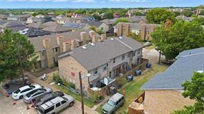 8001 Rothington Road, Unit 3137 Dallas, TX 75227 - Photo 2 of 21 Aerial perspective showcasing multiple two-story townhome structures with brick and siding exteriors
