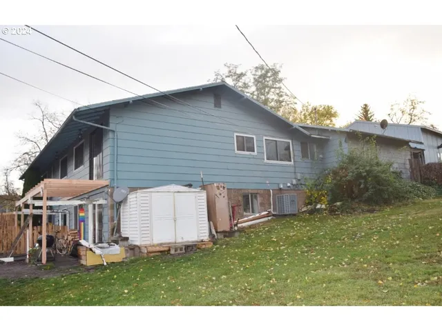 a view of a house with a yard and sitting area