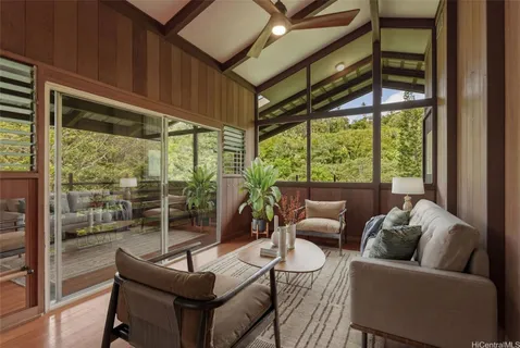 a living room with furniture a ceiling fan and a window