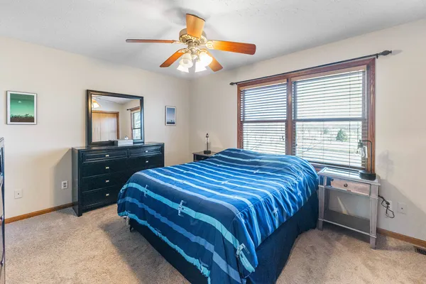 a bedroom with a bed and closet with mirror