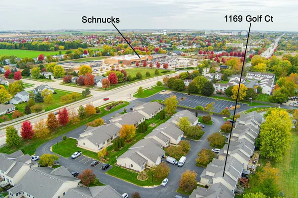 an aerial view of a house with garden space and swimming pool