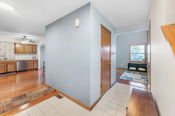 a view of kitchen with granite countertop a sink cabinets and wooden floor