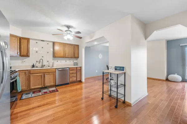 a kitchen with cabinets stainless steel appliances and a window