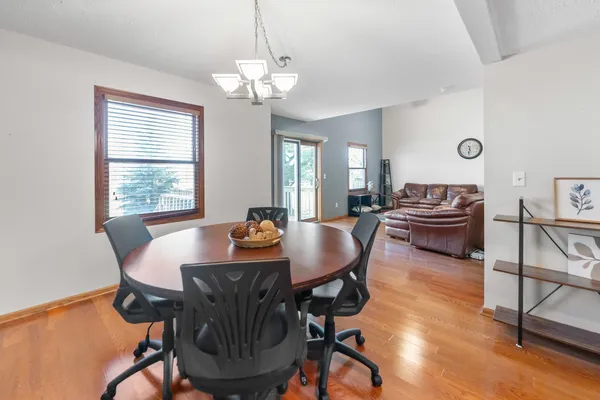 a view of a dining room with furniture and wooden floor