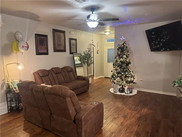 a living room with furniture and a christmas tree