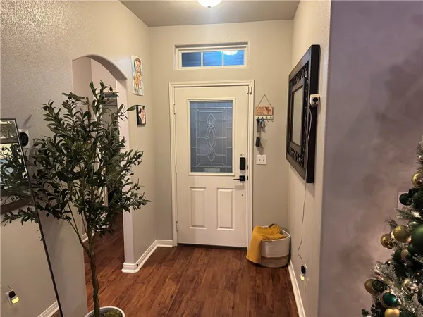 a view of an entryway with wooden floor