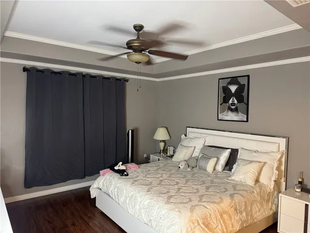 a bedroom with a bed and a painting on the wall